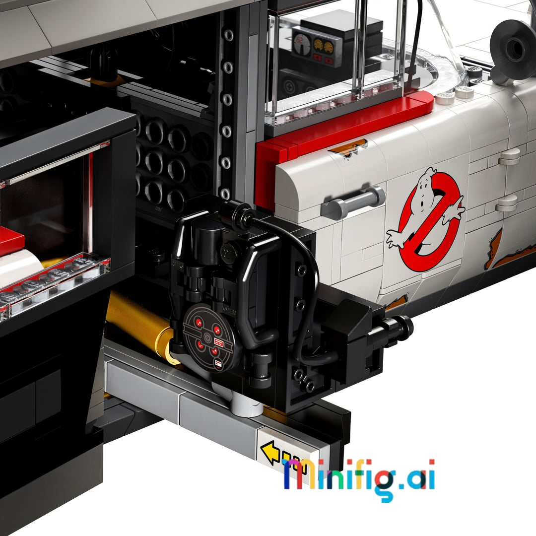 Close-up of a building block model vehicle with a black and red Ghostbusters-style logo on a white body, showing interior mechanical details and a yellow hose component.